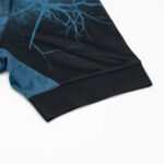 5s | UAE SPORT STORE Close-up of a dark blue jersey sleeve with a textured black ribbed cuff.