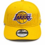 Yellow Los Angeles Lakers baseball cap with prominent purple Lakers logo embroidered on the front and a sticker on the bill.