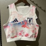 White sleeveless Adidas soccer jersey with pink cherry blossom pattern, featuring the Japan JFA crest on the left chest.