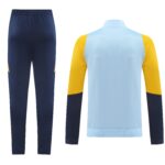 Navy athletic pants with a small yellow detail at the ankle beside a light blue long-sleeve color-block top with yellow sleeves (viewed from behind).