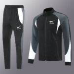 Nike Air tracksuit set: black zip jacket with gray sleeves and white panels, paired with black pants with white/gray accents.