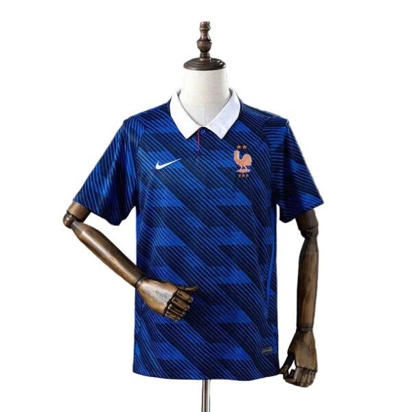 Blue France national team soccer jersey with white collar on a mannequin, featuring a Nike swoosh and rooster crest.