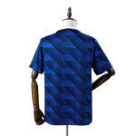 Blue short-sleeve shirt with diagonal pattern on a dress form, back view.