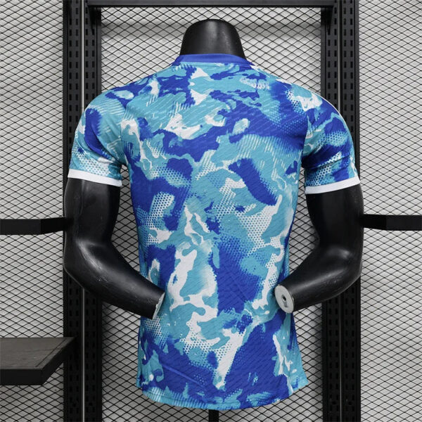 Blue camouflage athletic shirt on a mannequin seen from the back in a retail display rack