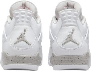 Rear view of two white Air Jordan sneakers with light gray speckled midsoles and Jumpman logos on the heels.