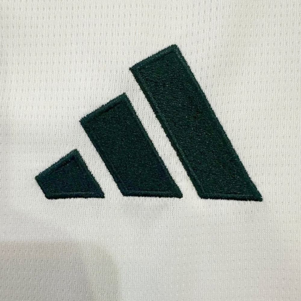 62633c5a-b782-4da0-8c2d-f3c5570518cc | UAE SPORT STORE Embroidered Adidas three-stripe logo in dark green on white fabric (close-up).