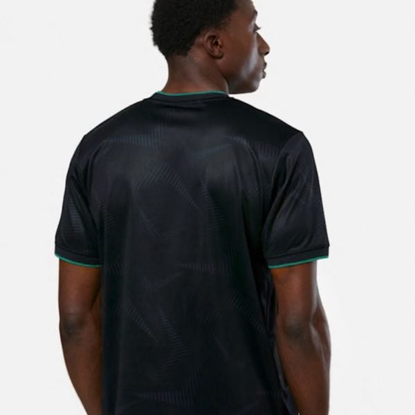 Back view of a man wearing a black athletic jersey with teal trim on the collar and sleeves.
