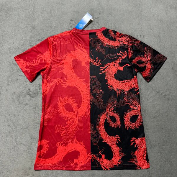 T-shirt with a red and black split design featuring red dragon motifs and a tag attached at the collar.