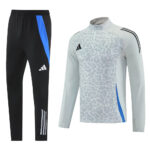 Adidas black track pants with blue side stripe and white stripes at the ankle paired with a light gray leopard-print training top with blue side panel.