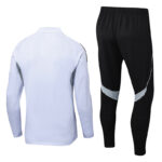 White athletic zipless jacket with gray side panels paired with black jogger pants featuring silver curved stripes, back view shown (tracksuit set)