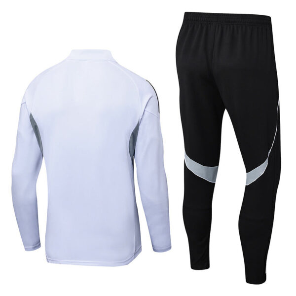 White athletic zipless jacket with gray side panels paired with black jogger pants featuring silver curved stripes, back view shown (tracksuit set)