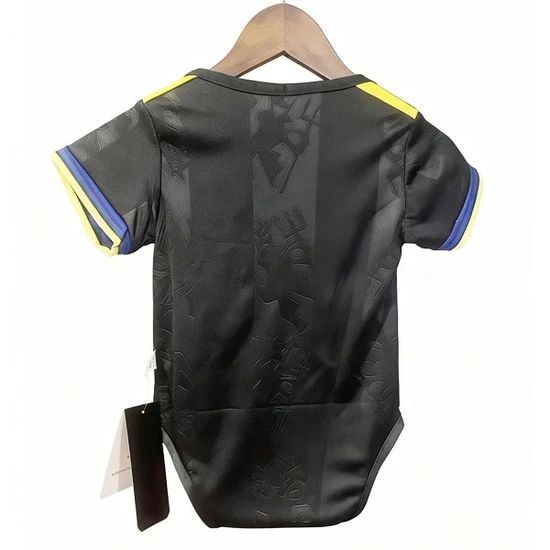 Back view of a black athletic jersey with yellow shoulder stripes and blue sleeve trim, hanging on a wooden hanger.