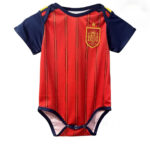 64b13100-199f-4b54-8c54-e3a4a79999c3 | UAE SPORT STORE Baby onesie designed to look like a Spain national football team jersey, red with navy sleeves and crest on the left chest.