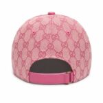 Pink baseball cap with Gucci monogram pattern, back view showing an adjustable pink strap and buckle.
