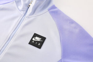 6590219d | UAE SPORT STORE Light purple and lavender Nike Air jacket with a front zipper and black Nike Air patch on the chest.