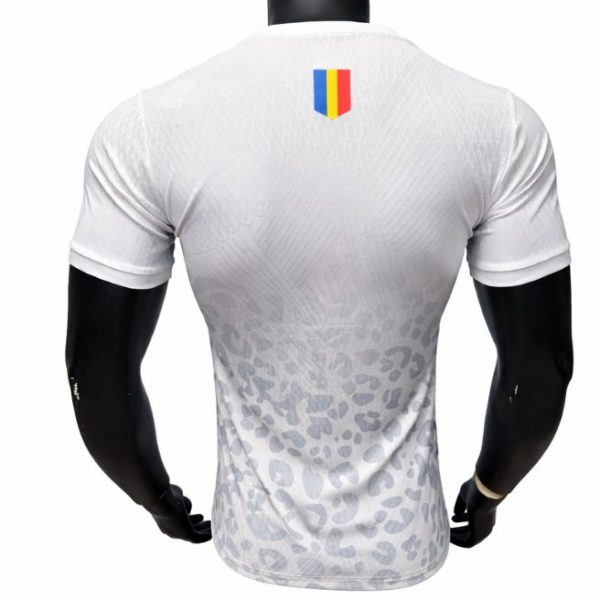 Back view of a white athletic jersey with a subtle grey leopard-like pattern and a small vertical tricolor shield on the upper back.