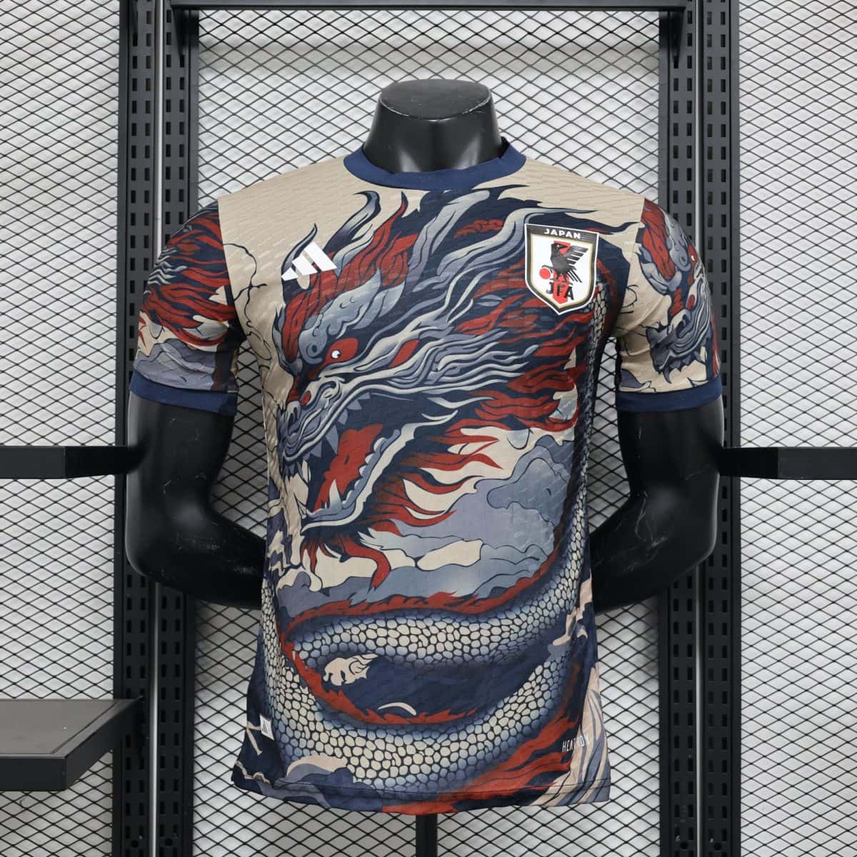 Mannequin torso wearing a dragon-patterned Japan national team jersey on a metal grid display shelf in a store