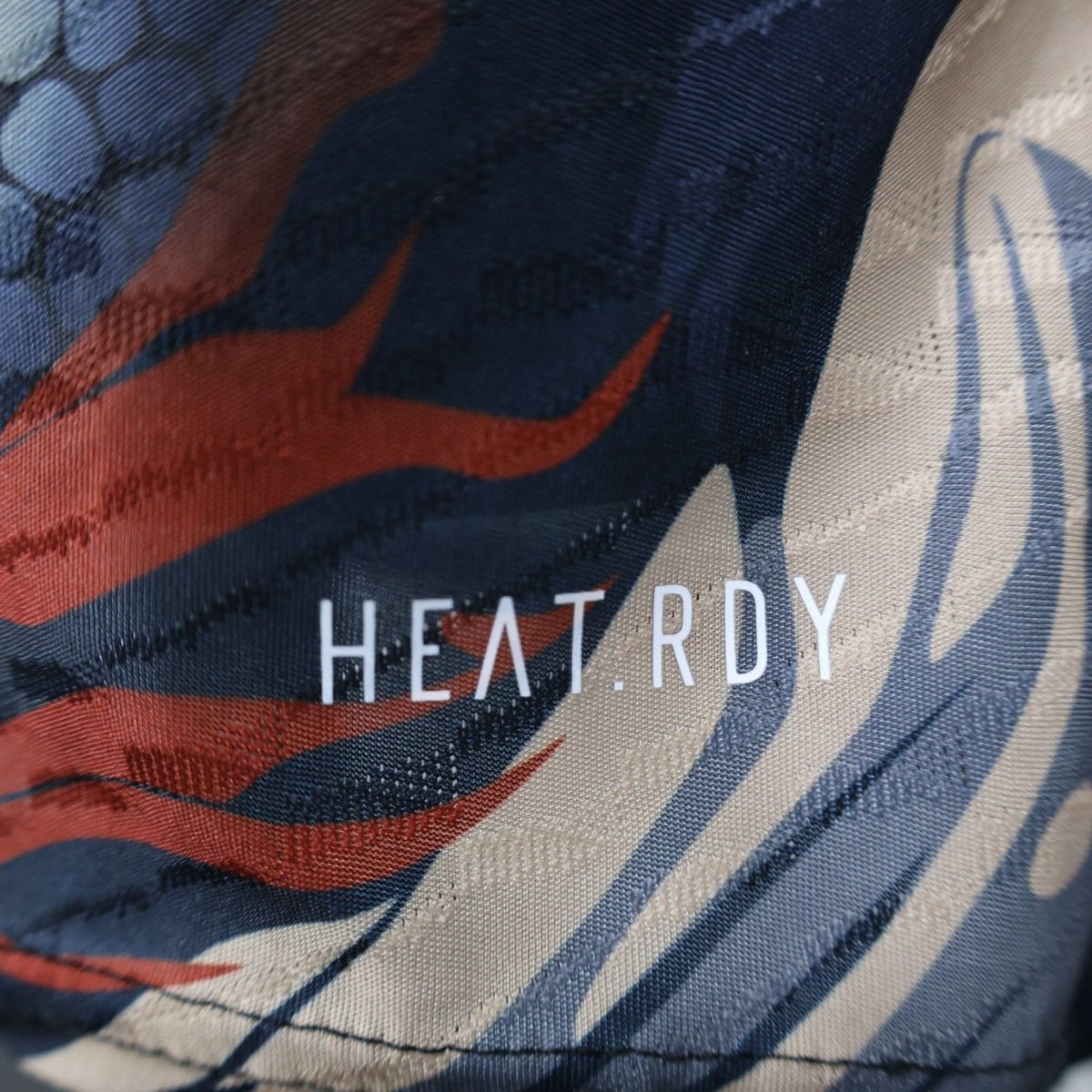 Close-up of striped fabric showing blue, red, and white woven stripes and texture.