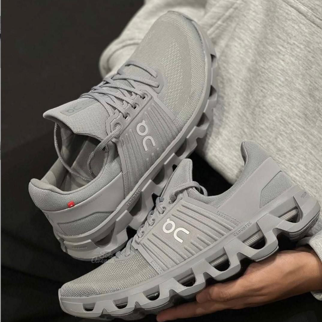 67d85645-be4a-4245-a354-59de82d55854 | UAE SPORT STORE Gray On running shoes with a segmented, cloud-like sole and breathable mesh upper.