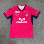 67f302638c.jpg.640x640 | UAE SPORT STORE Pink soccer jersey laid flat with navy trim on sleeves and collar; features a team crest, Mizuno logo, and prominent 'YANMAR' sponsor logo across the chest.