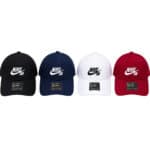 Nike SB baseball caps in black, navy, white, and red arranged in a row on a white background.