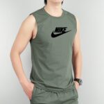 Person wearing a green sleeveless Nike shirt with a large black **Nike** swoosh logo on the chest, cropped mid-torso.