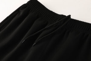 68bbf026 | UAE SPORT STORE Close-up of black drawstring waistband on a pair of jogger pants.