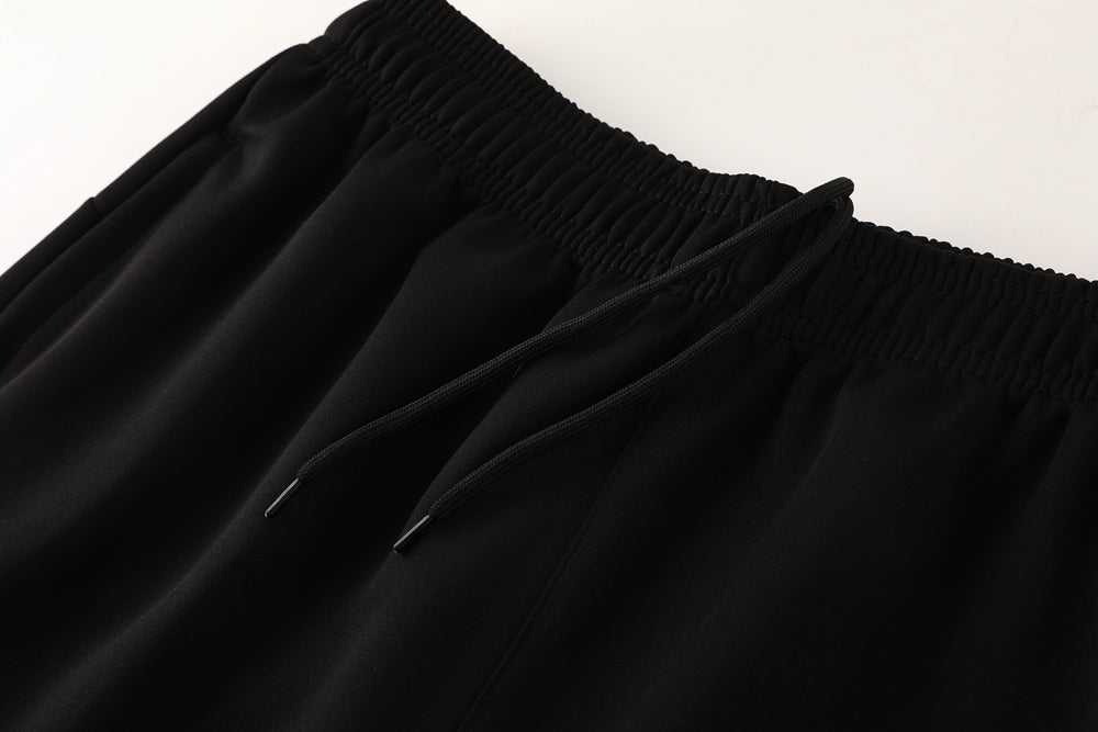 68bbf026 | UAE SPORT STORE Close-up of black drawstring waistband on a pair of jogger pants.