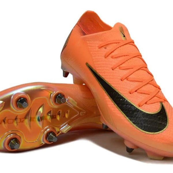 Orange soccer cleats with a black Nike swoosh and studded sole, angled to show both the top and bottom.