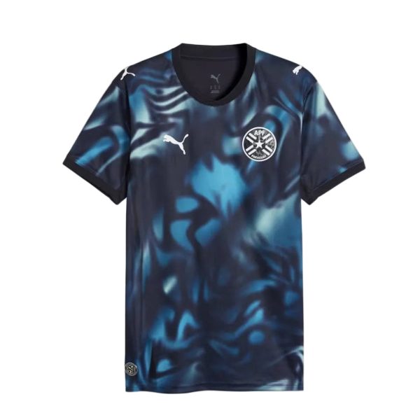 Blue and black abstract-pattern football jersey with Puma logo and APF Paraguay crest on chest.