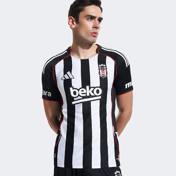 Male model wearing a black-and-white striped soccer jersey with Beko sponsor and club crest on the chest.