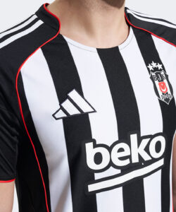 Close-up of a black-and-white striped football jersey featuring the Adidas logo and the 'beko' sponsor.