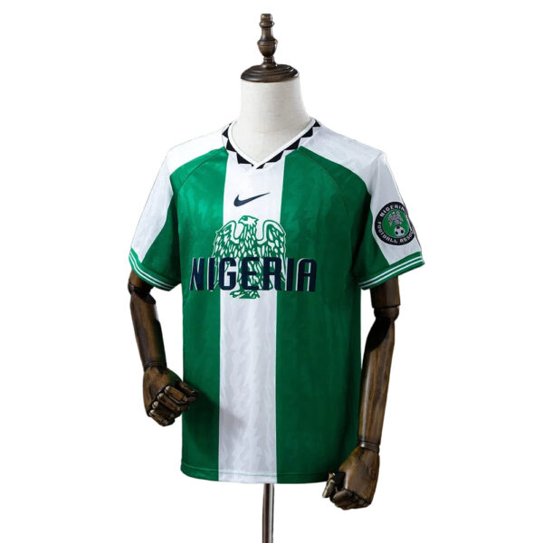 Nigeria national football team jersey on a dress form, green and white vertical stripes with crest and 'NIGERIA' text