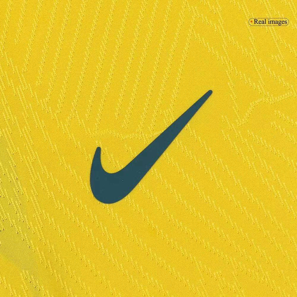 6ad93499-b7ed-4fc8-acac-86cc8cd1f003 | UAE SPORT STORE Dark teal Nike swoosh logo on a textured yellow fabric background.