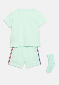 Mint green short-sleeve top and matching shorts with red and blue striped trim, laid out flat with a sock nearby (clothes set).