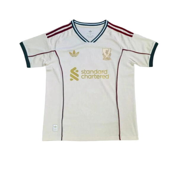 White Liverpool FC football jersey with burgundy shoulder stripes and Standard Chartered sponsor logo.