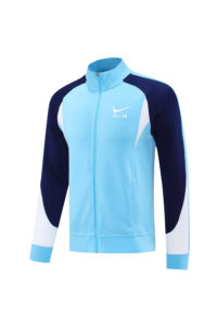 Light blue Nike Air track jacket with navy sleeves and white side panels, front zipper, on a white background