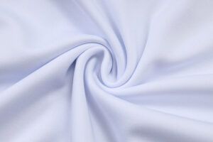 Close-up of light blue fabric twisted into a spiral, showing soft folds and texture.