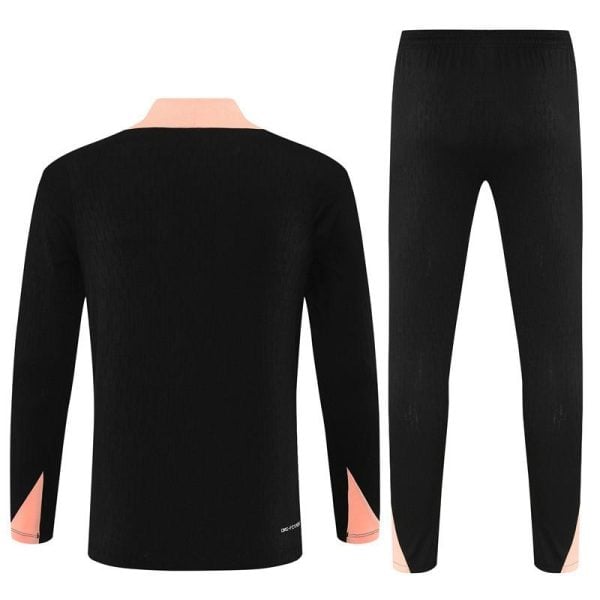 Back view of a black two-piece loungewear set with peach cuffs and collar, long-sleeve top and tapered pants from behind.