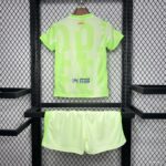 Neon lime-green sports jersey with matching shorts on a display rack; UNHCR logo on the back of the jersey.