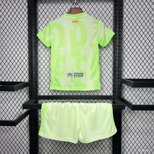 Neon lime-green sports jersey with matching shorts on a display rack; UNHCR logo on the back of the jersey.