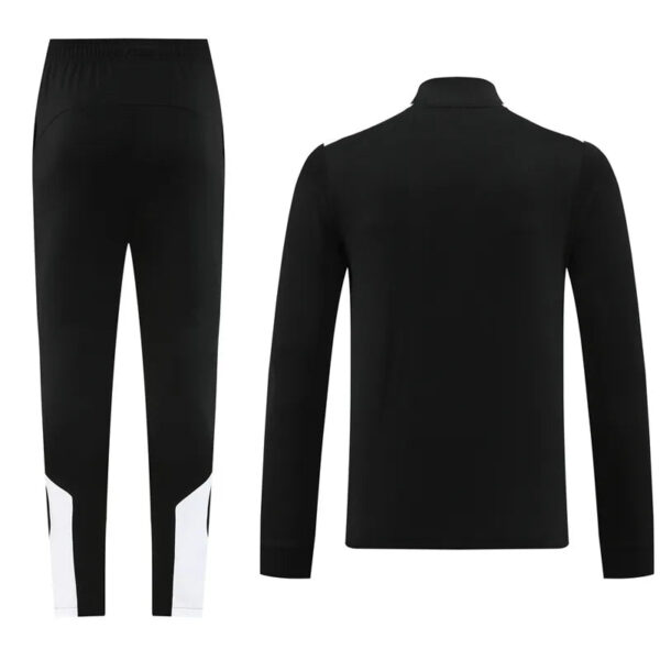 Pair of black athletic pants with white panels at the lower legs, shown from the back and side perspective