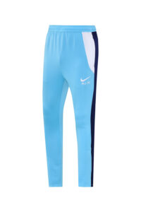 6d89fad4 | UAE SPORT STORE Light blue Nike Air track pants, side view with white panel and navy stripe along the leg, front logo visible
