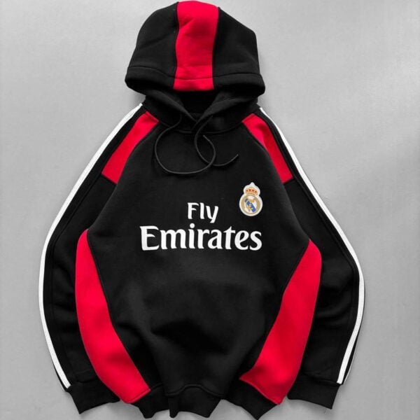 Black Real Madrid hoodie with red panels, white stripes, crest, and Fly Emirates sponsor.