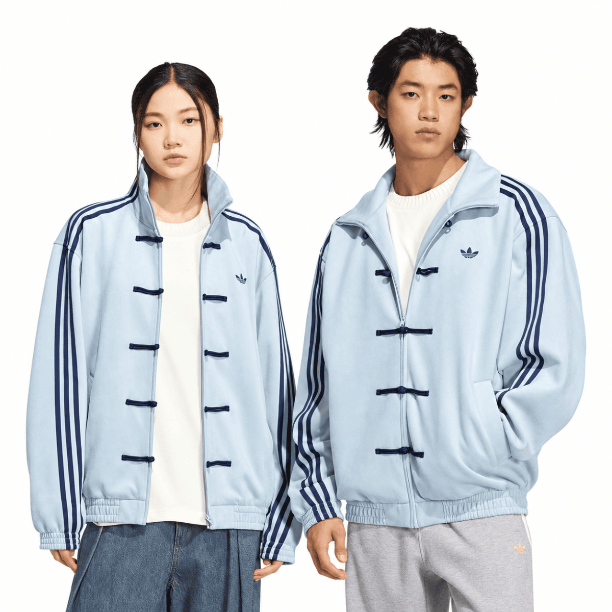 Unisex light grey Adidas casual jackets with blue stripes, worn by a woman and man.