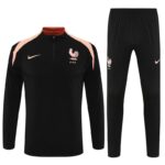 Black France national team training tracksuit with pink shoulder panels, rooster crest, and Nike logos on chest and pants.