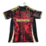 Red and black athletic jersey with yellow trim and a crest on the left chest, featuring bold gold text across the front.