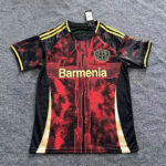 Red and black Borussia-style soccer jersey laid flat, with yellow accents and the word 'Barmenia' across the chest.