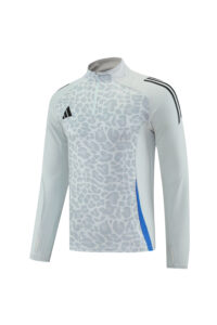 Light gray leopard-print athletic long-sleeve top with a half-zip collar, black logo, and blue side panel.