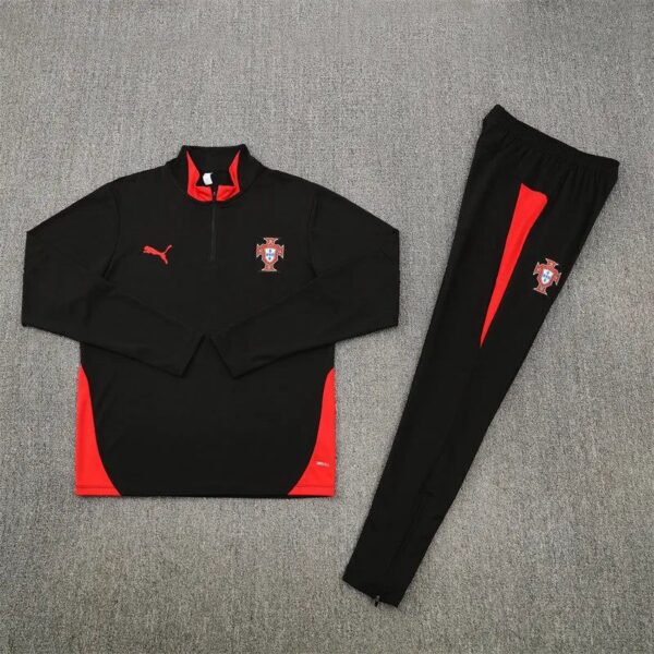 Portugal national football team training top and pants in black with red panels and crest, laid flat on carpet.